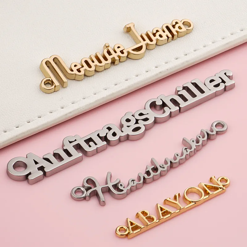 connected letters metal logo with sewing holes