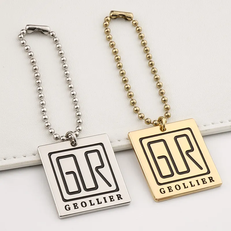 custom metal tag with black engraving logo