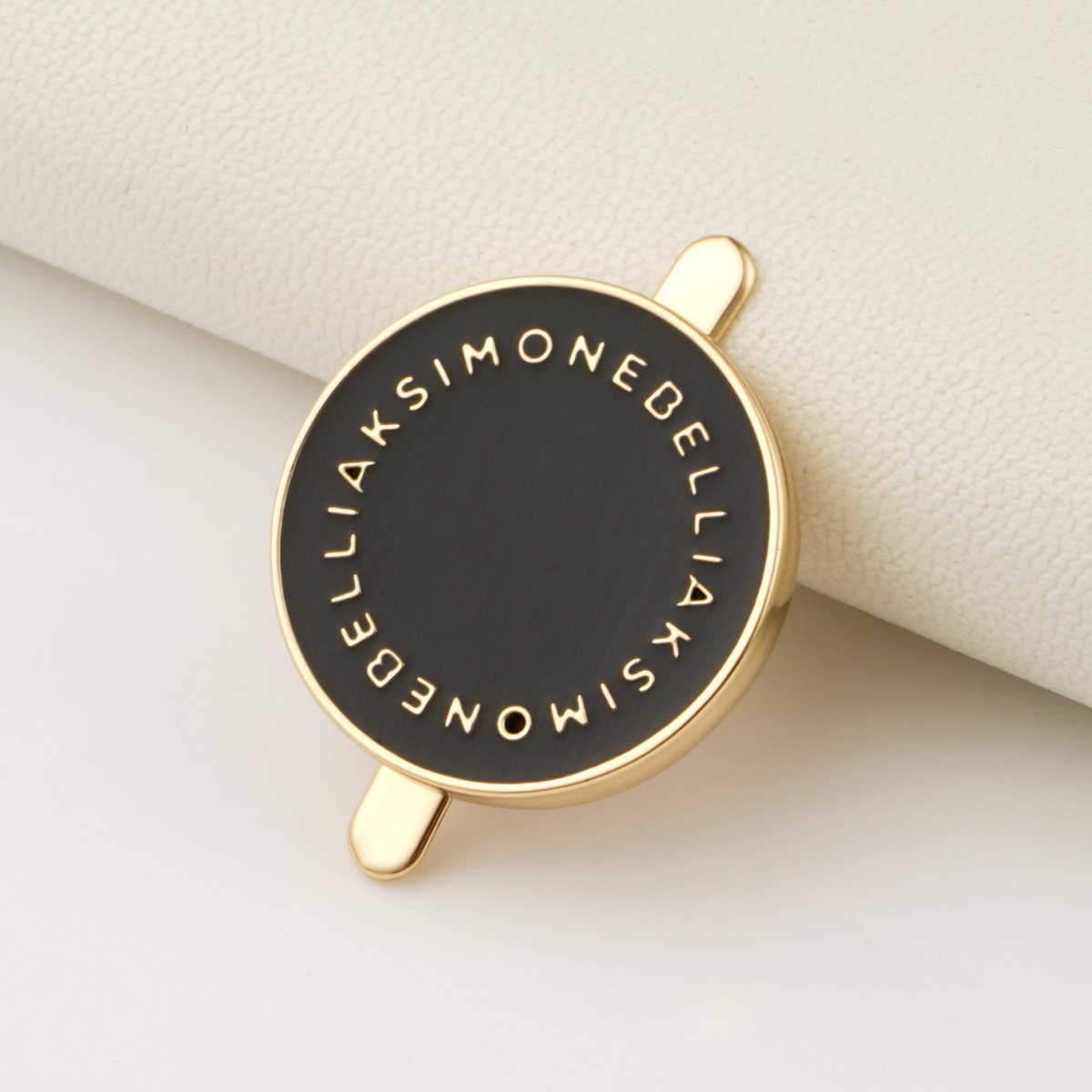 gold raised up logo metal tag with black background for bags