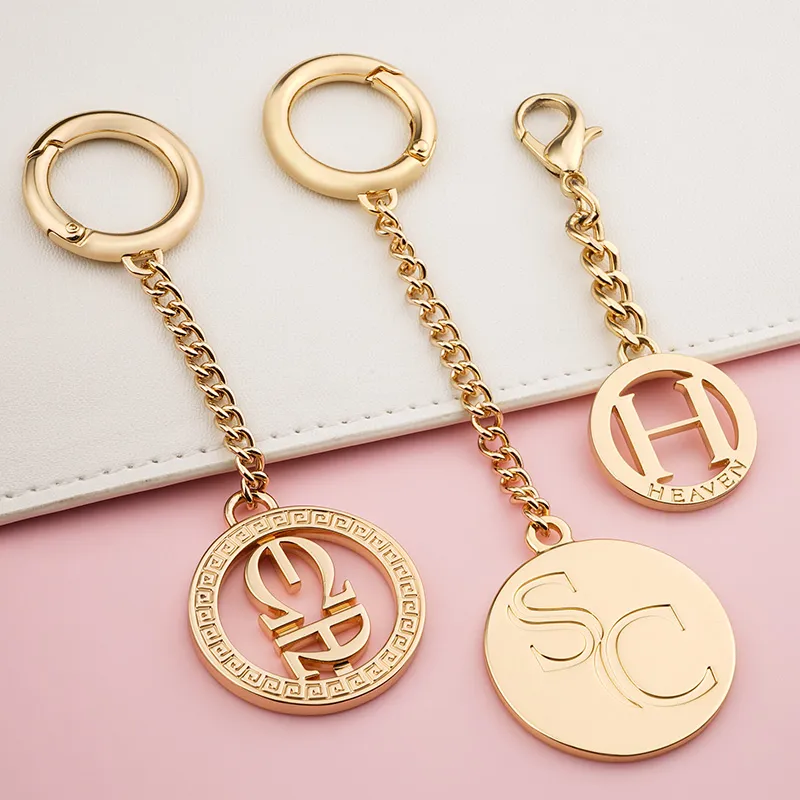 gold round metal tag with chain and hook
