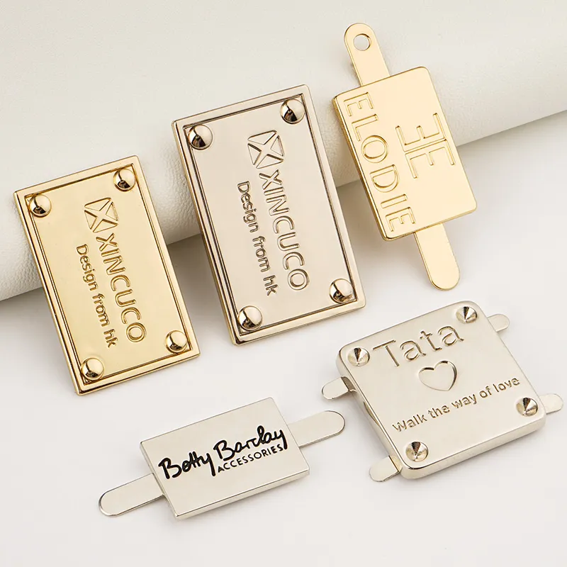 golden and silver metal logo label for bags