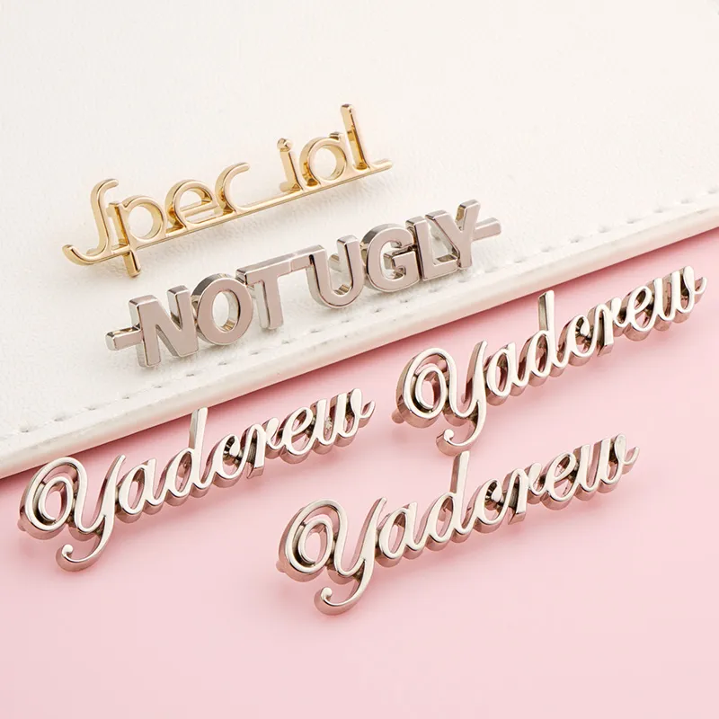 silver and gold letters logo metal for bags